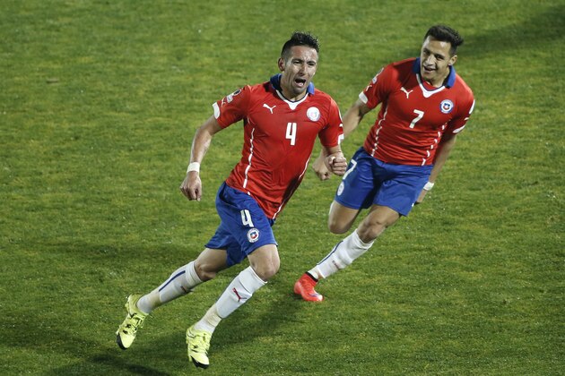 Chile's Mauricio Isla, left, celebrates after scoring against Uruguay with teammate Chile's Alexis Sanchez, right, during a Copa America quarterfinal soccer match at the National Stadium in Santiago, Chile, Wednesday, June 24, 2015. Chile won the match 1-0. (AP Photo/Silvia Izquierdo)