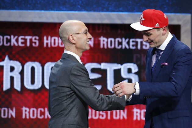 Sam Dekker, right, is greeted by NBA Commissioner Adam Silver after being selected 18th overall by the Houston Rockets during the NBA basketball draft, Thursday, June 25, 2015, in New York. (AP Photo/Kathy Willens)