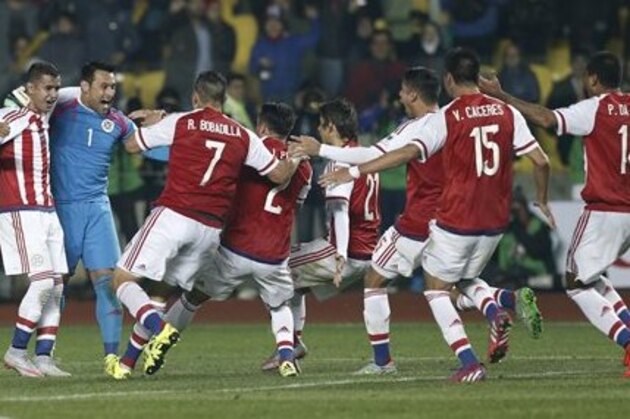 Paraguay's Derlis Gonzalez, left, and  goalkeeper Justo Villar, celebrate with their teammates after winning a Copa America quarterfinal soccer match against Brazil at the Ester Roa Rebolledo Stadium in Concepcion, Chile, Saturday, June 27, 2015. Paraguay defeated Brazil 4-3 in a penalty shoot out after the game ended in a 1-1 draw. (AP Photo/Silvia Izquierdo)