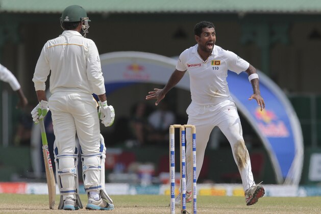 Sri Lankan bowler Dhammika Prasad celebrates taking the wicket of Pakistan's batsman Sarfraz Ahmed during the fourth day's play of their second test cricket match, in Colombo, Sri Lanka, Sunday, June 28, 2015. (AP Photo/Eranga Jayawardena)