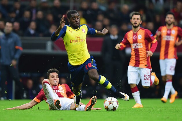 ISTANBUL, TURKEY - DECEMBER 09:  Joel Campbell of Arsenal is tackled by Alex Telles of Galatasaray during the UEFA Champions League Group D match between Galatasaray AS and Arsenal FC at Ali Sami Yen Arena on December 9, 2014 in Istanbul, Turkey.  (Photo by Jamie McDonald/Getty Images)