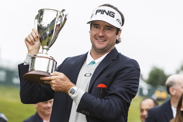 Jun 28, 2015; Cromwell, CT, USA; Bubba Watson hold up the Travelers Championship trophy after defeating Paul Casey in two sudden death holes in the final round of the Travelers Championship at TPC River Highlands. Mandatory Credit: David Butler II-USA TODAY Sports