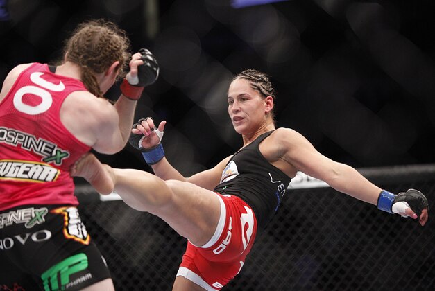 Oct 19, 2013; Houston, TX, USA; Sarah Kaufman (red gloves) fights against Jessica Eye (blue gloves) in their women's bantamweight bout during UFC 166 at Toyota Center. Mandatory Credit: Andrew Richardson-USA TODAY Sports