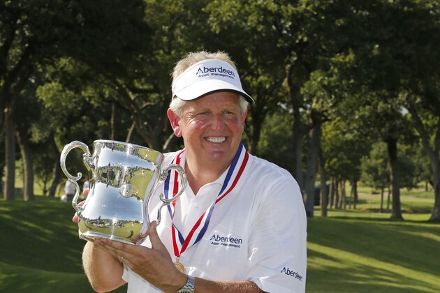 Colin Montgomerie poses with the Francis D. Ouimet Memorial Trophy after winning the 2014 U.S. Senior Open golf tournament at Oak Tree National in Edmond, Okla., Sunday, July 13, 2014. Montgomerie won in a playoff over Gene Sauers. (AP Photo/Sue Ogrocki)