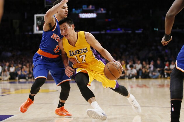Los Angeles Lakers' Jeremy Lin, right, drives against New York Knicks' Shane Larkin during the first half of an NBA Basketball game, Thursday, March 12, 2015, in Los Angeles. (AP Photo/Danny Moloshok)