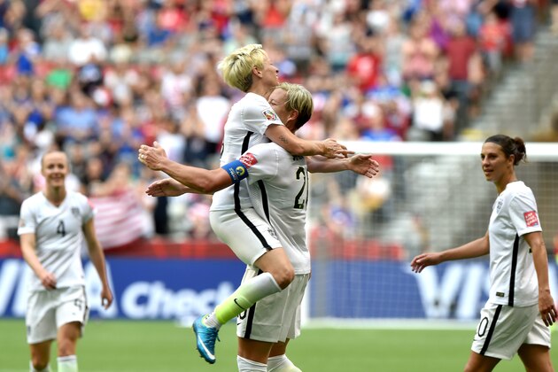 VANCOUVER, BC - JUNE 16:  Abby Wambach #20 of the United States celebrates with Megan Rapinoe #15 after Wambach scores a goal in the first half against Nigeria in the Group D match of the FIFA Women's World Cup Canada 2015 at BC Place Stadium on June 16, 2015 in Vancouver, Canada.  (Photo by Rich Lam/Getty Images)