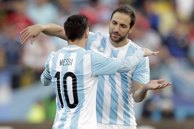 Argentina's Lionel Messi, left, embraces Gonzalo Higuain at the start of a Copa America Group B soccer match at the Sausalito Stadium in Vina del Mar, Chile, Saturday, June 20, 2015. (AP Photo/Ricardo Mazalan)