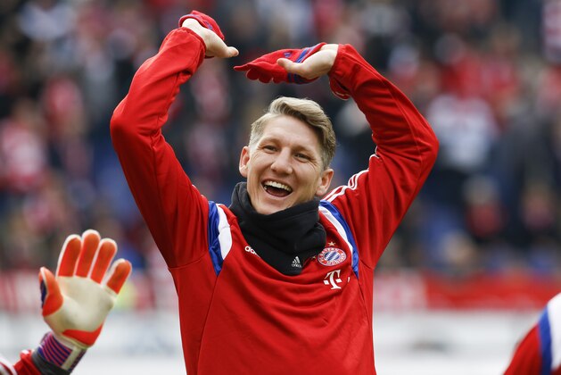 Bayern's Bastian Schweinsteiger jokes with teammates prior to the German first division Bundesliga soccer match between Hannover 96 and Bayern Munich in Hannover, Germany, Saturday, March 7, 2015. (AP Photo/Markus Schreiber)