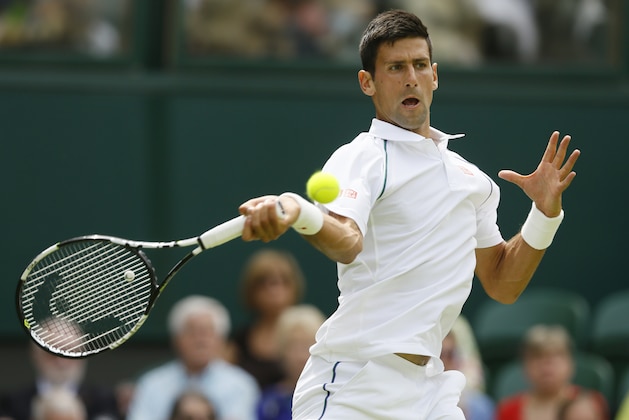 Novak Djokovic of Serbia plays a return to Philipp Kohlschreiber of Germany during the men's singles first round match at the All England Lawn Tennis Championships in Wimbledon, London, Monday June 29, 2015. (AP Photo/Kirsty Wigglesworth)