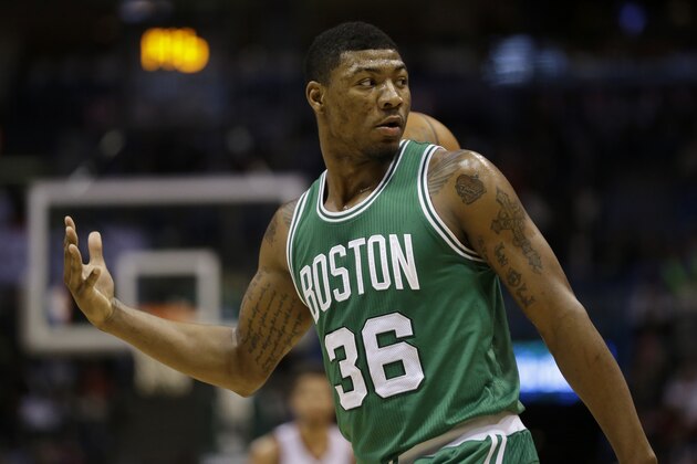 Boston Celtics' Marcus Smart passes the ball to a referee during an NBA basketball game against the Milwaukee Bucks Wednesday, April 15, 2015, in Milwaukee. (AP Photo/Aaron Gash)