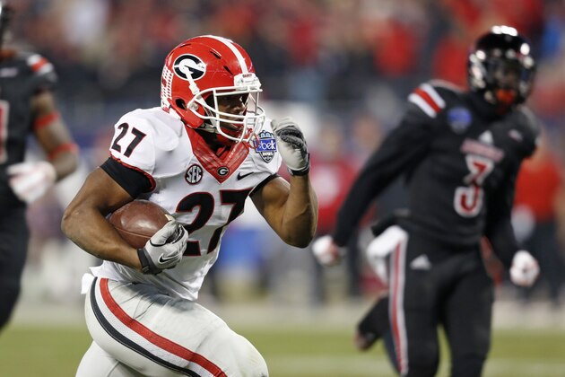 Georgia's Nick Chubb (27) runs for a touchdown against Louisville during the first half of the Belk Bowl NCAA college football game in Charlotte, N.C., Tuesday, Dec. 30, 2014. (AP Photo/Nell Redmond)
