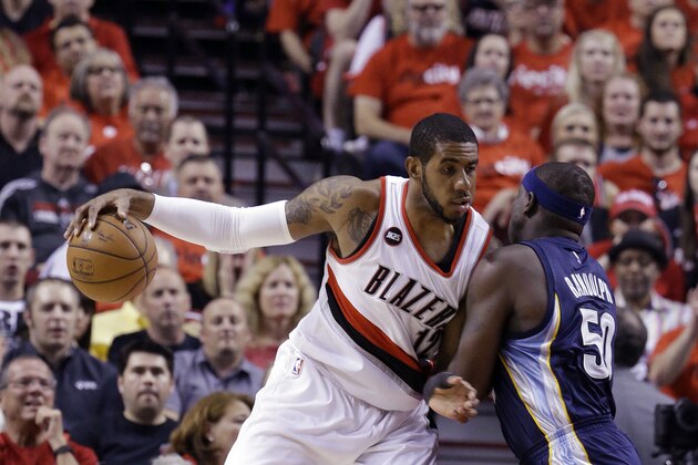 Portland Trail Blazers forward LaMarcus Aldridge, left, works the ball in against Memphis Grizzlies forward Zach Randolph during the first half of Game 4 of a first-round NBA basketball playoff series in Portland, Ore., Monday, April 27, 2015.  (AP Photo/Don Ryan)