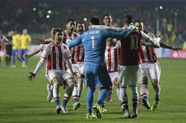 Paraguay's players celebrate after the penalty shootout during a Copa America quarterfinal soccer match at the Ester Roa Rebolledo Stadium in Concepcion, Chile, Saturday, June 27, 2015. Paraguay defeated Brazil 4-3 in a penalty shootout after a 1-1 draw on Saturday to advance to the semifinals of the Copa America.(AP Photo/Natacha Pisarenko)