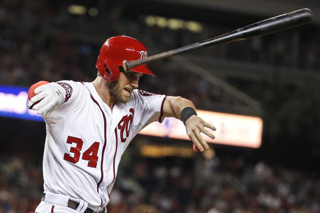 Washington Nationals' Bryce Harper throws his bat after flying out to right field during the ninth inning of a baseball game against the Atlanta Braves at Nationals Park, Wednesday, June 24, 2015, in Washington. The Nationals won 2-1 in 11 innings. (AP Photo/Alex Brandon)