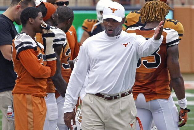Texas coach Charlie Strong gestures during the first quarter of the NCAA college football team's Orange and White spring game, Saturday, April 18, 2015, in Austin, Texas. (AP Photo/Michael Thomas)