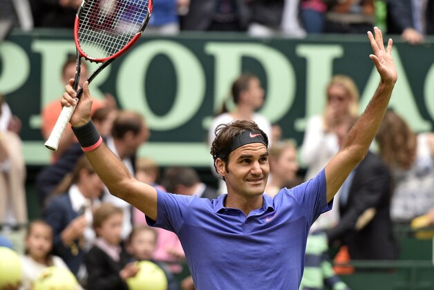 Roger Federer of Switzerland celebrates after winning the final match against Andreas Seppi of Italy at the Gerry Weber Open ATP tennis tournament in Halle, Germany, Sunday, June 21, 2015. Federer defeated Seppi with 7-6 and 6-4. (AP Photo/Martin Meissner)