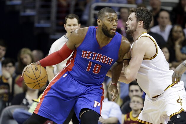 Detroit Pistons' Greg Monroe (10) drives on Cleveland Cavaliers' Kevin Love in an NBA basketball game Monday, April 13, 2015, in Cleveland. (AP Photo/Mark Duncan)