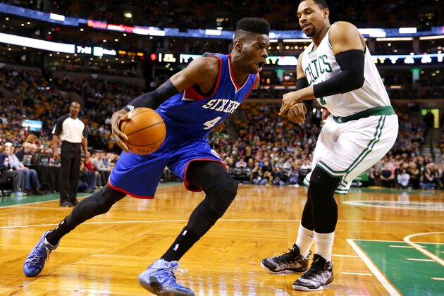 Philadelphia 76ers' Nerlens Noel (4) drives on Boston Celtics' Jared Sullinger during the first quarter of an NBA basketball game in Boston Friday, Feb. 6, 2015. (AP Photo/Winslow Townson)