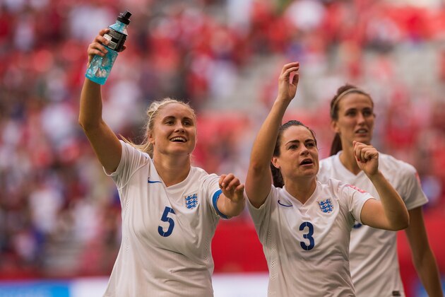VANCOUVER, BC - JUNE 27: Steph Houghton #5 and Claire Rafferty #3 of England celebrate with fans after defeating Canada 2-1 in the FIFA Women's World Cup Canada 2015 Quarter Final match between the England and Canada June, 27, 2015 at BC Place Stadium in Vancouver, British Columbia, Canada.  (Photo by Rich Lam/Getty Images)