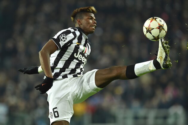 TURIN, ITALY - DECEMBER 09:  Paul Pogba of Juventus controls the ball during the UEFA Champions League group A match between Juventus and Club Atletico de Madrid at Juventus Arena on December 9, 2014 in Turin, Italy.  (Photo by Valerio Pennicino/Getty Images)