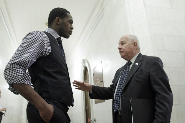 FILE - In this May 23, 2011 file photo, Ultimate Fighting Championship light heavyweight title holder Jon Jones, left, talks with Sen. William Larkin Jr., R-New Windsor, at the Capitol in Albany, N.Y. A bill to legalize MMA in New York has passed the Senate but failed again last week, still facing Assembly opposition. (AP Photo/Mike Groll, File)