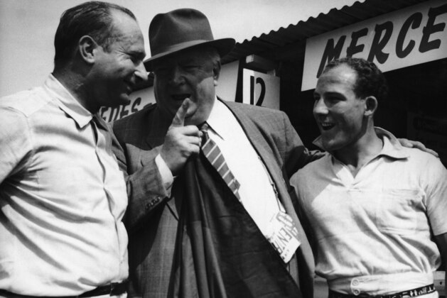 Alfred Neubauer, center, manager of the German Mercedes racing team, has a word with two of his drivers - Juan Manuel Fangio, left, of Argentine and Stirling Moss of Britain, before they set out on practice laps at the Aintree Course at Liverpool, England, United Kingdom, on July 14, 1955. Mercedes have entered three cars for the British grand prix there on July 16. The third driver (unshown) is Karl Kling of Germany. (AP Photo/Laurence Harris) Alfred Neubauer, center, manager of the German Mercedes racing team, has a word with two of his drivers - Juan Manuel Fangio, left, of Argentine and Stirling Moss of Britain, before they set out on practice laps at the Aintree Course at Liverpool, England, United Kingdom, on July 14, 1955. Mercedes have entered three cars for the British grand prix there on July 16. The third driver (unshown) is Karl Kling of Germany. (AP Photo/Laurence Harris)