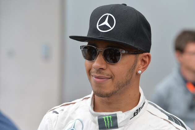 Mercedes driver Lewis Hamilton of Britain walks away after the second training session prior to the Formula One Grand Prix, at the Red Bull Ring in Spielberg, southern Austria, Friday, June 19, 2015. (AP Photo/Kerstin Joensson)