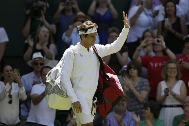 Roger Federer of Switzerland arrives on court to play Damir Dzumhur of Bosnia in the singles first round match at the All England Lawn Tennis Championships in Wimbledon, London, Tuesday June 30, 2015. (AP Photo/Tim Ireland)