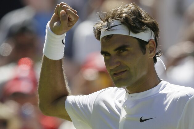 Roger Federer of Switzerland celebrates after defeating Damir Dzumhur of Bosnia in the singles first round match at the All England Lawn Tennis Championships in Wimbledon, London, Tuesday June 30, 2015. (AP Photo/Tim Ireland)