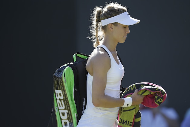 Eugenie Bouchard of Canada leaves the court after losing to Ying-Ying Duan of China in the singles first round match at the All England Lawn Tennis Championships in Wimbledon, London, Tuesday June 30, 2015. (AP Photo/Pavel Golovkin)
