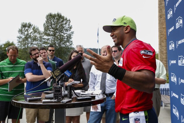 Seattle Seahawks quarterback Russell Wilson answers questions during a press conference following an NFL football minicamp Thursday, June 18, 2015, in Renton, Wash. (AP Photo/Joe Nicholson)