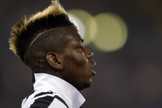 Juventus' Paul Pogba runs on the pitch during their Italian Cup soccer final match between Lazio and Juventus at Rome's Olympic stadium, Wednesday, May 20, 2015. (AP Photo/Gregorio Borgia)