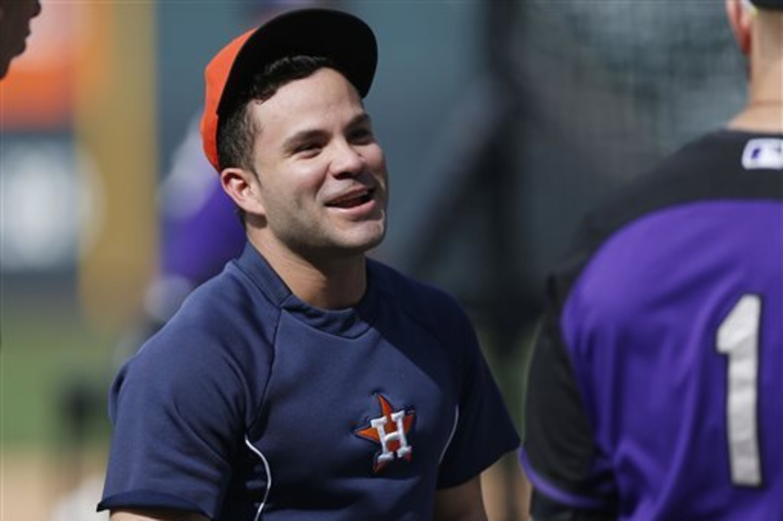 RETRANSMISSION TO CORRECT DATE -  Houston Astros second baseman Jose Altuve jokes with a Colorado Rockies player before an interleague baseball game Wednesday, June 17, 2015, in Denver. (AP Photo/David Zalubowski)