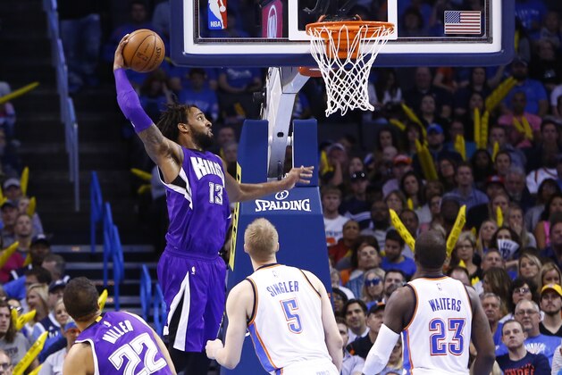 Sacramento Kings forward Derrick Williams (13) goes up for a dunk as Oklahoma City Thunder forward Kyle Singler (5) and Oklahoma City Thunder guard Dion Waiters (23) look on during the second half of an NBA basketball game in Oklahoma City, Friday, April 10, 2015. Oklahoma City won 116-103. (AP Photo/Alonzo Adams)