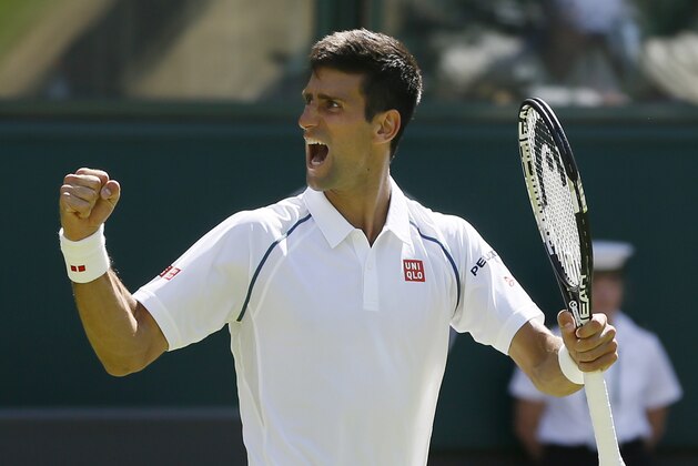 Novak Djokovic of Serbia celebrates defeating Philipp Kohlschreiber of Germany in their men's singles first round match at the All England Lawn Tennis Championships in Wimbledon, London, Monday June 29, 2015. Djokovic won the match 6-4, 6-4, 6-4. (AP Photo/Kirsty Wigglesworth)