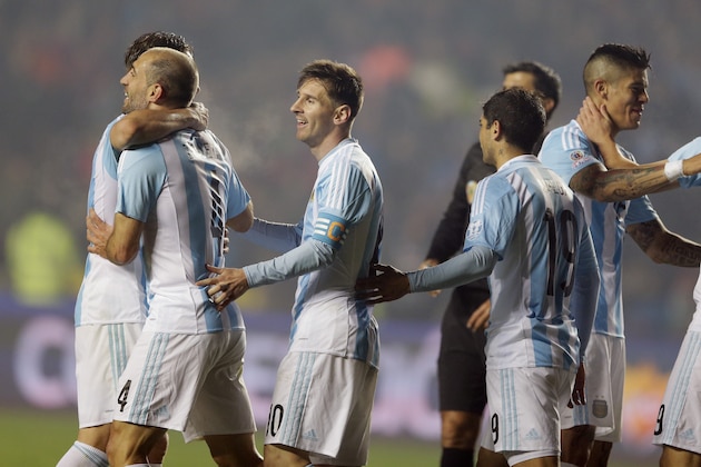 Argentina's Lionel Messi, third left, and teammates hug at the end of their Copa America semifinal soccer match against Paraguay  at the Ester Roa Rebolledo Stadium in Concepcion, Chile, Tuesday, June 30, 2015. (AP Photo/Ricardo Mazalan)