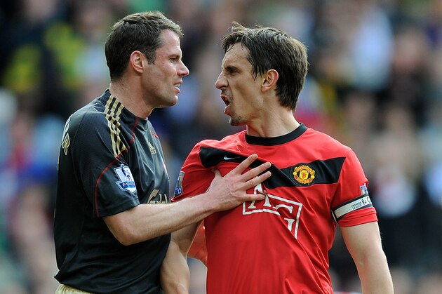 MANCHESTER, ENGLAND - MARCH 21: Jamie Carragher (L) of Liverpool argues with Gary Neville of Manchester United after United were awarded a penalty in the first half of the Barclays Premier League match between Manchester United and Liverpool at Old Trafford on March 21, 2010 in Manchester, England.  (Photo by Michael Regan/Getty Images)