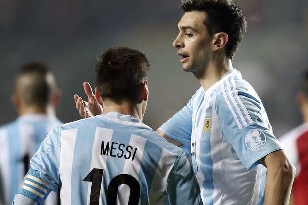 Argentina's Javier Pastore, right,  celebrates with teammate Lionel Messi , after he scored his team's second goal during a Copa America semifinal soccer match at the Ester Roa Rebolledo Stadium in Concepcion, Chile, Tuesday, June 30, 2015. Argentina beat Paraguay 6-1 in the Copa America semifinals on Tuesday, setting up a final against host Chile.(AP Photo/Silvia Izquierdo)