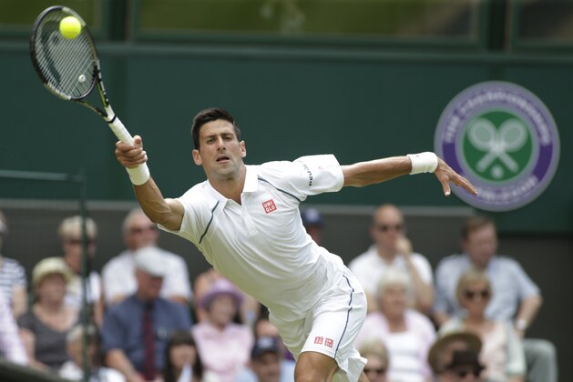 Novak Djokovic of Serbia serves to Jarkko Nieminen of Finland, during their singles match at the All England Lawn Tennis Championships in Wimbledon, London, Wednesday July 1, 2015. (AP Photo/Alastair Grant)