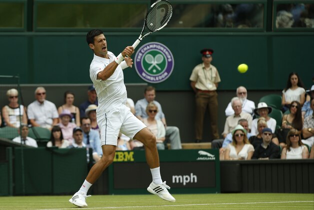 Novak Djokovic of Serbia returns a ball to Jarkko Nieminen of Finland, during their singles match at the All England Lawn Tennis Championships in Wimbledon, London, Wednesday July 1, 2015. (AP Photo/Alastair Grant)