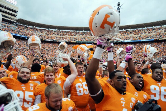 Oct 19, 2013; Knoxville, TN, USA; Members of the Tennessee Volunteers football team celebrate with fans after defeating the South Carolina Gamecocks  at Neyland Stadium. Tennessee won 23 to 21.  Mandatory Credit: Randy Sartin-USA TODAY Sports