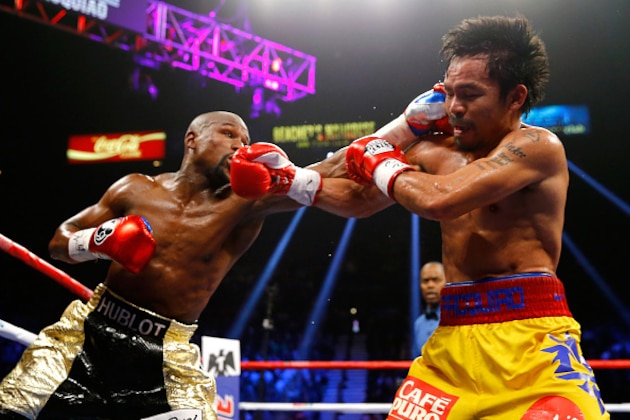 LAS VEGAS, NV - MAY 02:  Floyd Mayweather Jr. exchange punches with Manny Pacquiao during their welterweight unification championship bout on May 2, 2015 at MGM Grand Garden Arena in Las Vegas, Nevada.  (Photo by Al Bello/Getty Images)