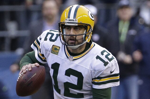 Green Bay Packers quarterback Aaron Rodgers (12) scrambles against the Seattle Seahawks during the second half of the NFL football NFC Championship game Sunday, Jan. 18, 2015, in Seattle. (AP Photo/David J. Phillip)