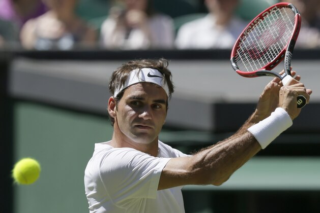 Roger Federer of Switzerland returns a ball to Damir Dzumhur of Bosnia during their singles first round match at the All England Lawn Tennis Championships in Wimbledon, London, Tuesday June 30, 2015. (AP Photo/Tim Ireland)