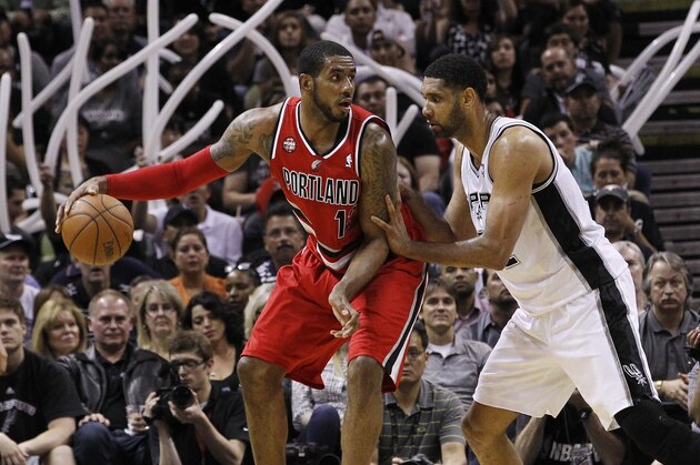 SAN ANTONIO, TX - MAY 14:  LaMarcus Aldridge #12 of the Portland Trail Blazers attempts to drive around Tim Duncan #21 of the San Antonio Spurs in Game Five of the Western Conference Semifinals during the 2014 NBA Playoffs at the AT&T Center on May 14, 2014 in San Antonio, Texas. NOTE TO USER: User expressly acknowledges and agrees that, by downloading and/or using this photograph, user is consenting to the terms and conditions of the Getty Images License Agreement. (Photo by Chris Covatta/Getty Images)