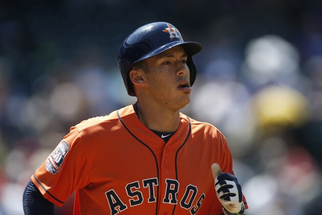 Houston Astros shortstop Carlos Correa heads to first base after drawing a walk against the Colorado Rockies in the fifth inning of an interleague baseball game Thursday, June 18, 2015, in Denver. (AP Photo/David Zalubowski)