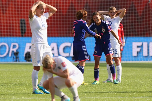 EDMONTON, AB - JULY 01:  Mizuho Sakaguchi and Rumi Utsugi of Japan celebrate after the FIFA Women's World Cup Semi Final match between Japan and England at the Commonwealth Stadium on July 1, 2015 in Edmonton, Canada.  (Photo by Ronald Martinez/Getty Images)