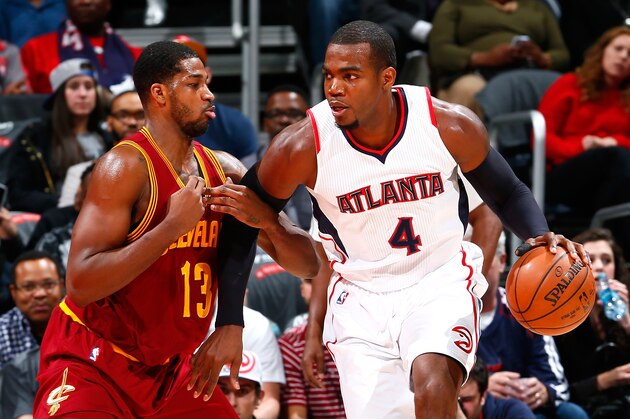 ATLANTA, GA - DECEMBER 30:  Paul Millsap #4 of the Atlanta Hawks drives against Tristan Thompson #13 of the Cleveland Cavaliers at Philips Arena on December 30, 2014 in Atlanta, Georgia.  NOTE TO USER: User expressly acknowledges and agrees that, by downloading and or using this photograph, User is consenting to the terms and conditions of the Getty Images License Agreement.  (Photo by Kevin C. Cox/Getty Images)