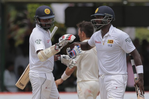 Sri Lankan captain Angelo Mathews, right, congratulates Lahiru Thirimanne after defeating Pakistan by 7 wickets in their second cricket test match in Colombo, Sri Lanka, Monday, June 29, 2015. (AP Photo/Eranga Jayawardena)