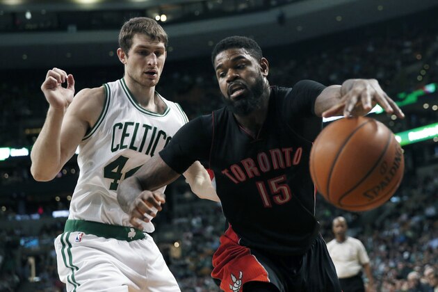 Toronto Raptors' Amir Johnson (15) keeps the ball inbounds in front of Boston Celtics' Tyler Zeller (44) during the fourth quarter of an NBA basketball game in Boston, Tuesday, April 14, 2015. The Celtics won 95-93. (AP Photo/Michael Dwyer)